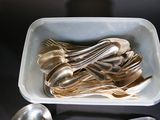 a lot of silver spoons and spoons in a bowl