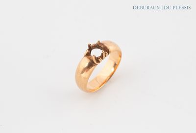 a close up of a gold ring with a diamond on it