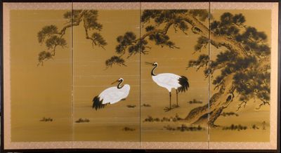two cranes standing under a tree in a field next to a tree