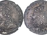 a close up of two silver coins on a white surface