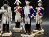 three figurines of men dressed in military uniforms stand in a row