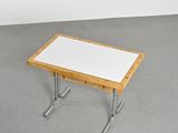 an image of a white table with a wooden top and metal legs