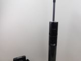 a vacuum that is sitting on the floor next to a charger