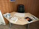 a desk with a chair and a book on it