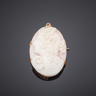 an antique carved cameo of a woman with flowers in her hair