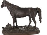 a statue of a horse that is standing on a rock