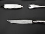five different types of silverware on a black surface
