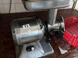a meat grinder sitting on a counter in a kitchen