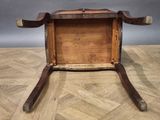 an old wooden box with a handle sitting on top of a hard wood floor