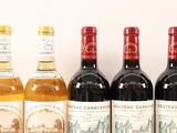 several bottles of wine are lined up on a table