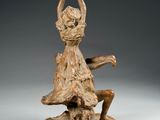 an image of a statue of a woman sitting on top of a rock