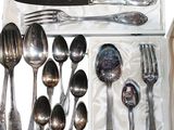 a lot of spoons and forks in a box
