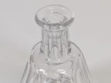 a clear glass vase with a clear base on a white surface