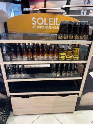 many bottles of beer on display in a store