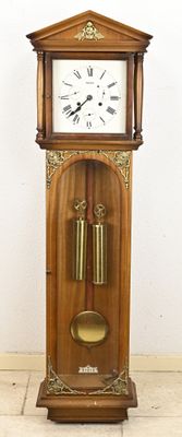 a grandfather clock sitting on the floor in a room