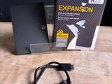 the external hard drive is sitting next to the box of the external hard drive