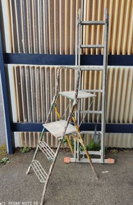 two ladders that are leaning against a wall
