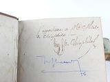 an open book with a handwritten note on it sitting on a table