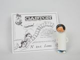a small figurine of a man in a space suit next to a card