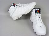 pair of white sneakers with colorful patches on them on a white surface