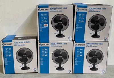 four boxes of fan sitting on top of each other on a table