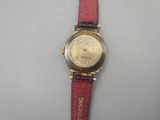 an image of a close up of a wrist watch on a table