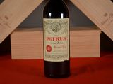 a bottle of wine sitting on a table next to a wooden box