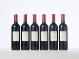 six bottles of red wine lined up in a row