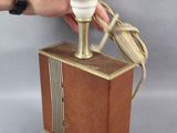 a person holding a lamp that is on a table