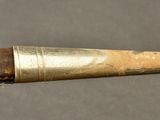 a pipe that has a wooden handle on it