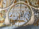 a picture of a bed with a picture of animals and birds on it