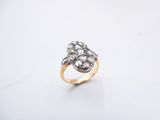 an image of a gold and diamond ring on a white surface