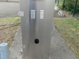 an image of a public toilet on a sidewalk