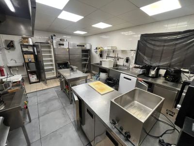 a large kitchen with a lot of stainless steel counter tops