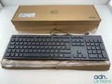 a black keyboard and a brown box on a white table