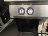 stainless steel counter top in a commercial kitchen with two burners on each side