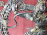 a statue of a woman holding a snake in her hand