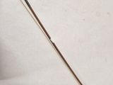 a close up of a wooden stick with a long stick sticking out of it