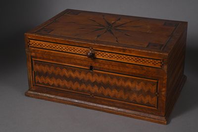 an old wooden box with a star design on the lid