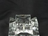an image of a glass candle holder on a black background