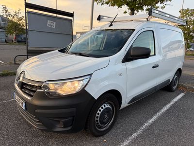 the white van is parked in a parking lot near a tree