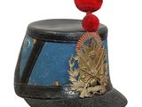 a hat with a red pom pom on top of it