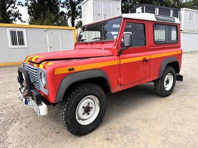 an image of a red land rover parked in a parking lot