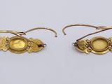 two pairs of gold earrings with yellow stones on them