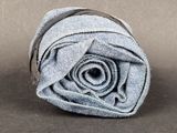 a rolled up towel that is on a brown surface