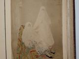 an old photo of a woman in a wedding dress sitting on a chair