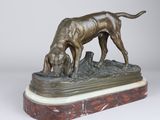 bronze statue of a dog and a cat on a marble base