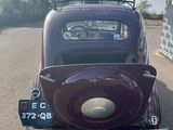 an old car parked on the side of the road