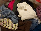 a pile of clothes that is sitting on the floor