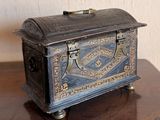 a small metal box sitting on a wooden table